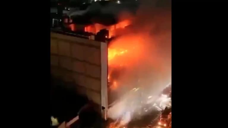 New center burns in Iraq: 77 people killed