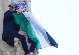 An activist carrying a Palestinian flag climbs Big Ben (photo) фото