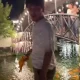A man was caught on video catching a fish with his bare