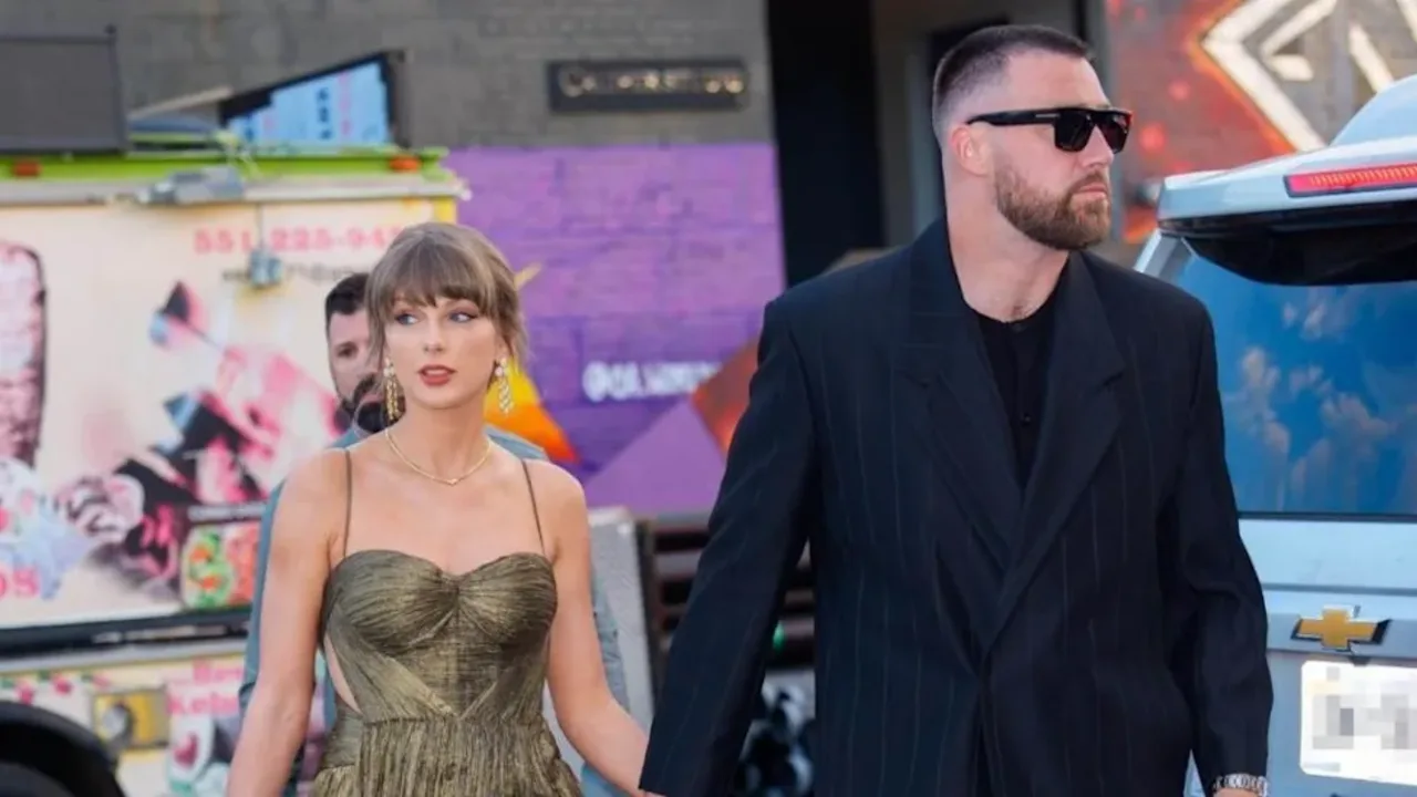 Teylor Svift va Trevis Kelsi ko'chada qo'l ushlashib yurishibdi.