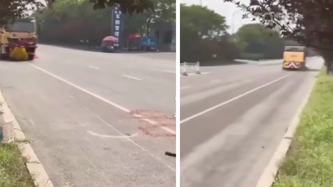 Katta yo'lda ketayotgan sariq rangli yuk mashinasi va asfalt ustidagi qon izi.