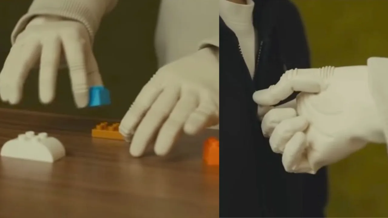 Oq qo‘lqopdagi robot qo‘llari lego bloklarini termoqda va kiyim molniyasini tutmoqda.