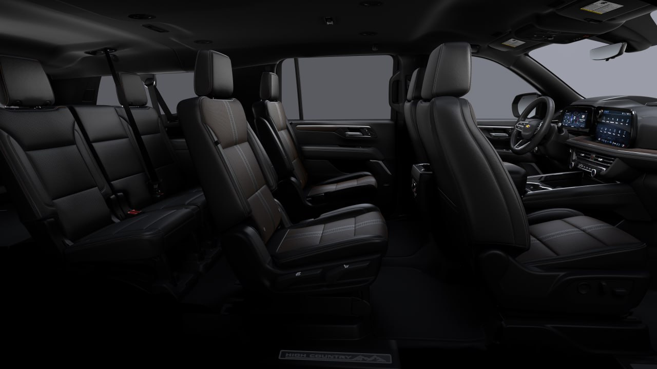 The spacious and luxurious interior of the car with black leather seats.