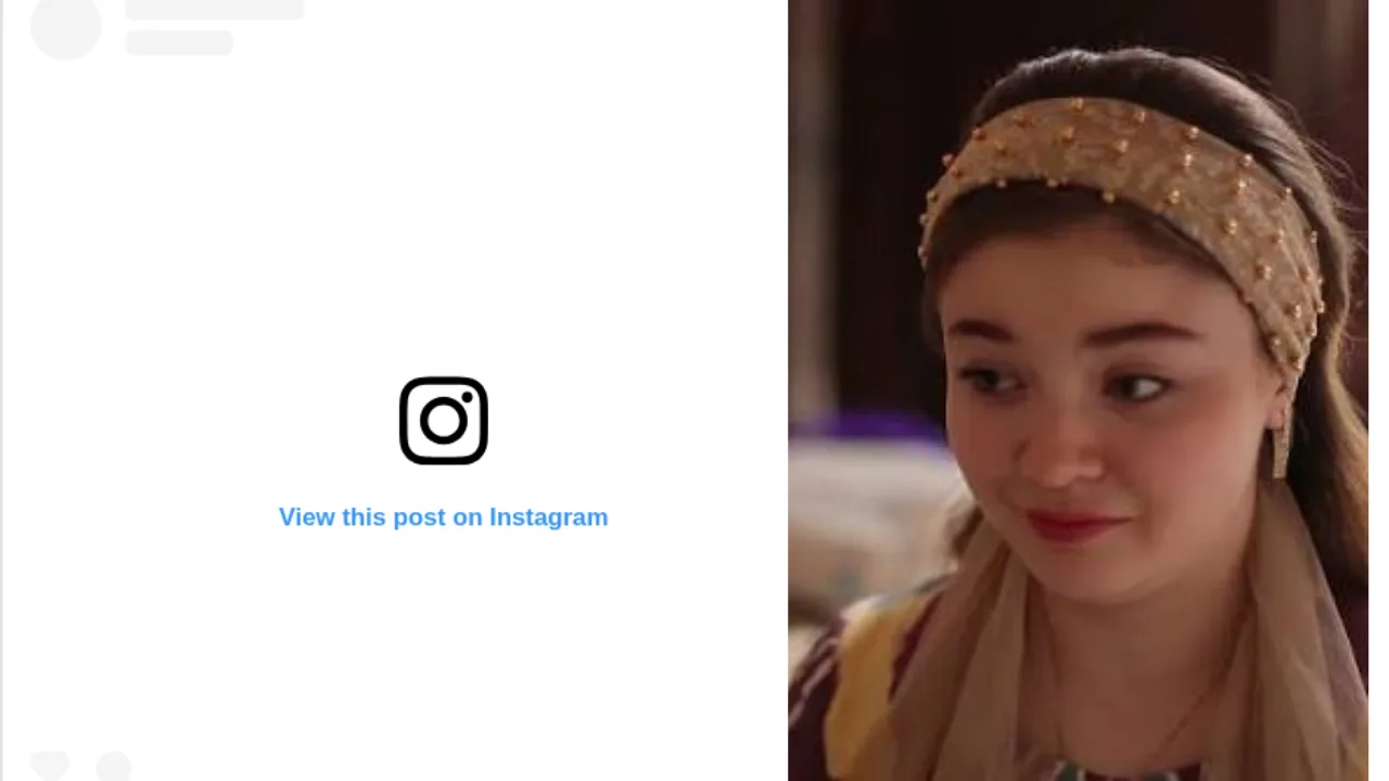 Bezakli bosh kiyim kiygan qiz Instagram posti yonida turibdi.