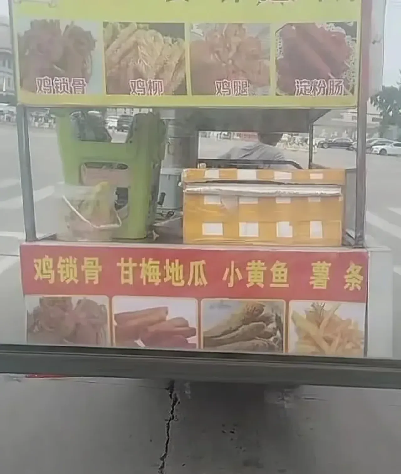 Turli xil qovurilgan taomlar suratlari va xitoycha yozuvlari bo‘lgan ko‘chma taom peshtaxtasi.
