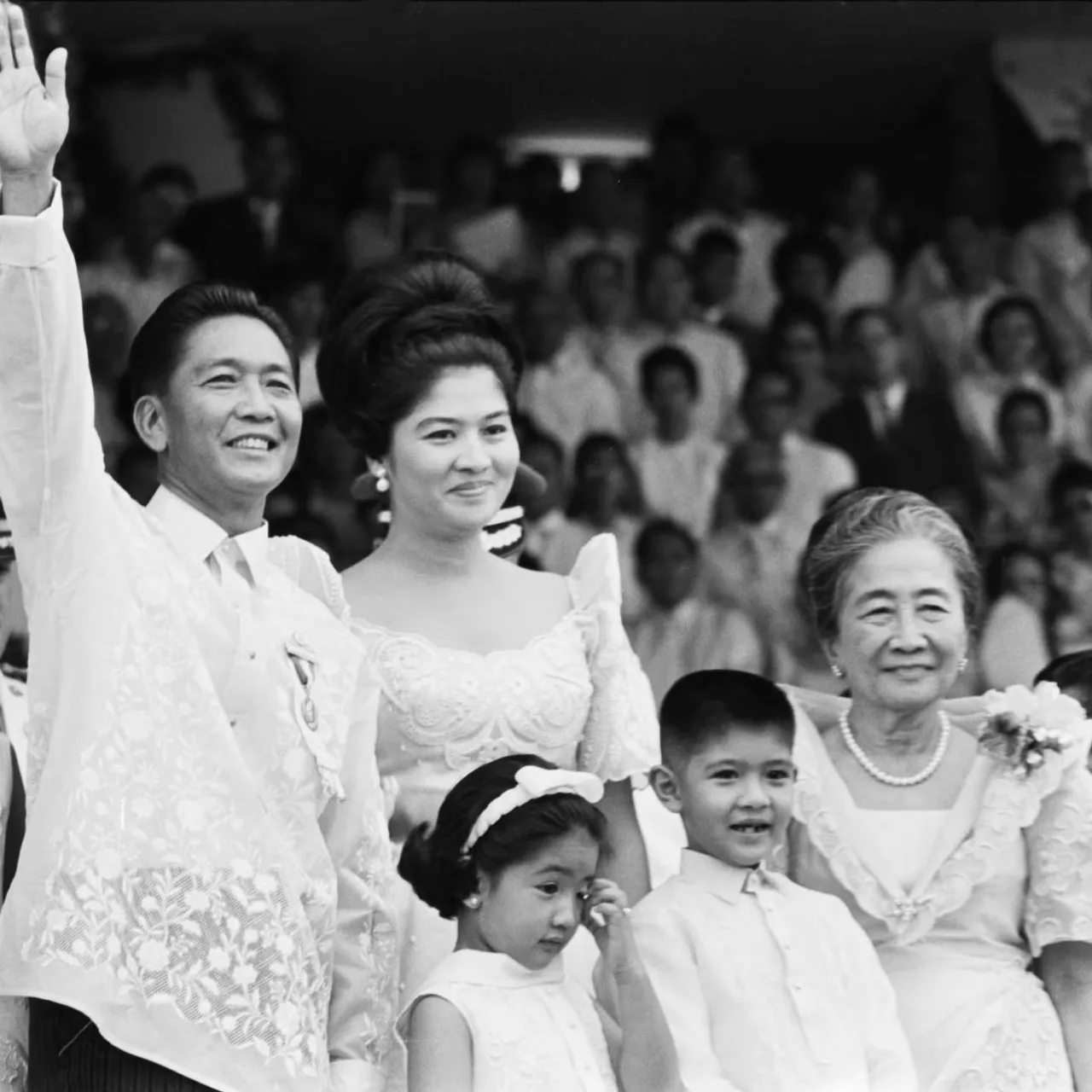 Ferdinand Marcos oilasi bilan birga ommaviy tadbirda turibdi.