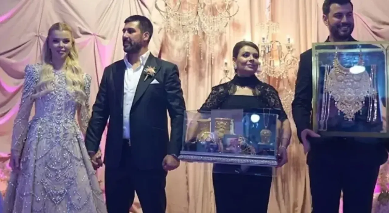 To‘y libosidagi kelin-kuyov va sovg‘a sifatida zargarlik buyumlarini ko‘targan insonlar.