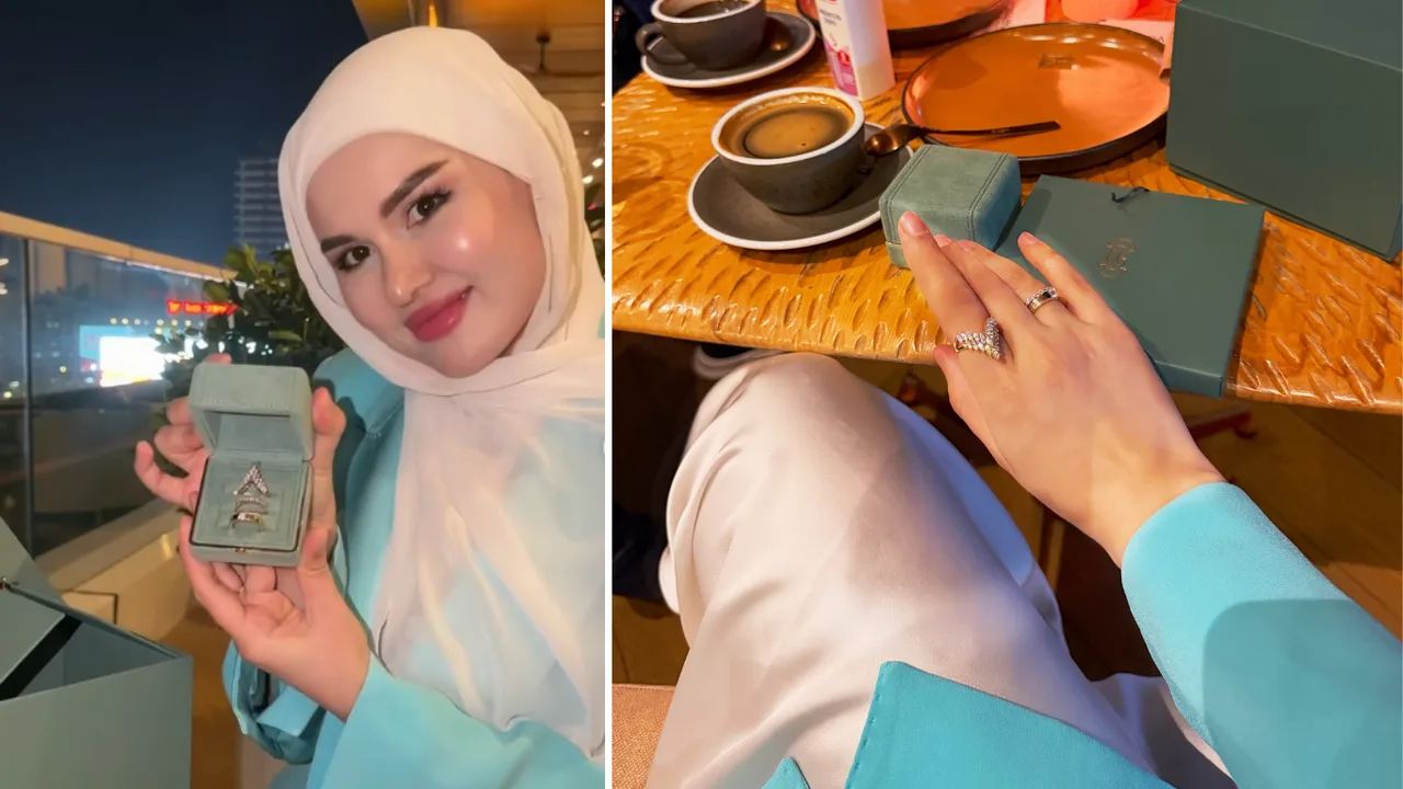A woman in a hijab is showing the rings in a small box and wearing them on her finger.