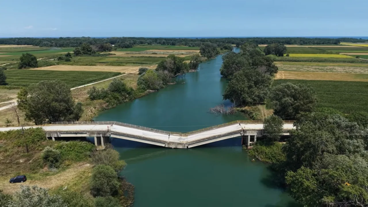 The central part of the concrete bridge over the river has collapsed.