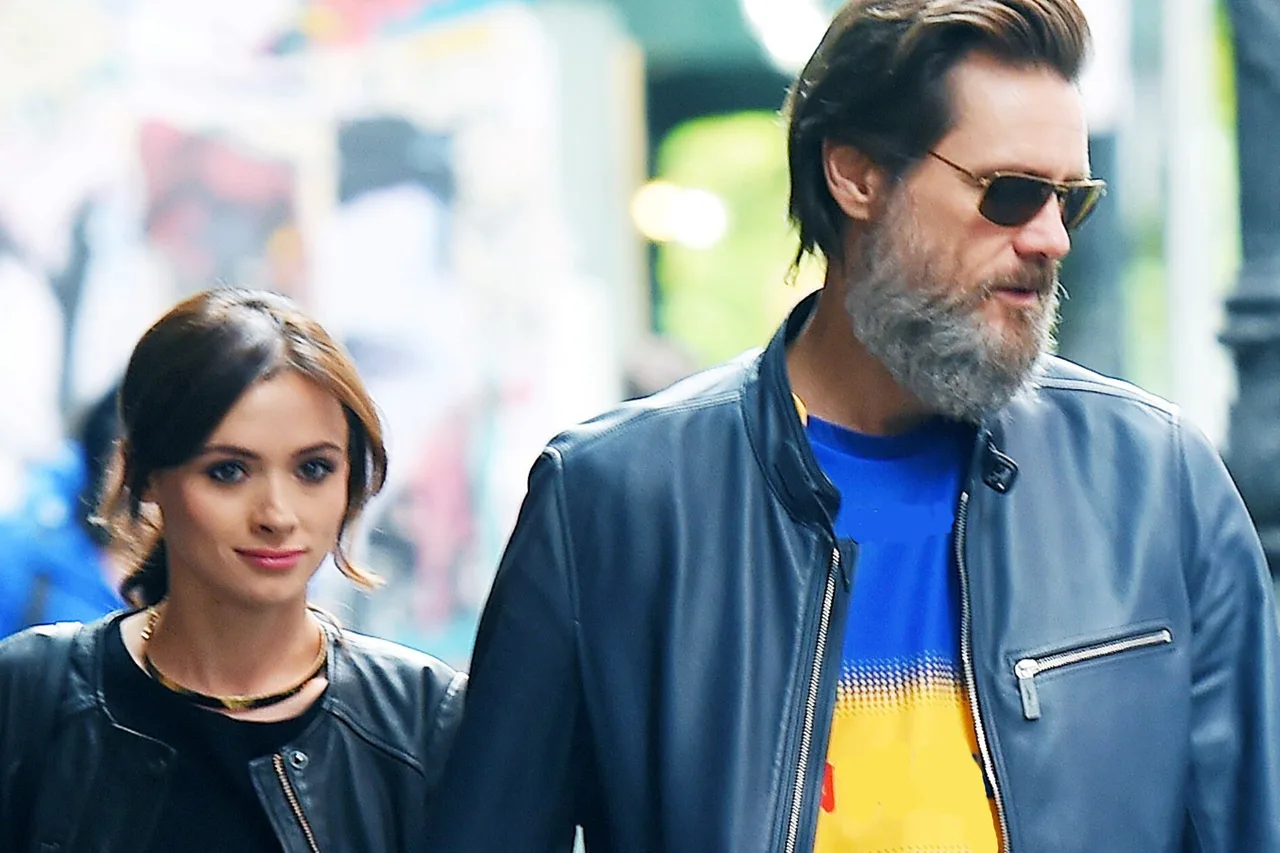 Jim Carrey and Cathriona White walking together on the street.